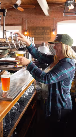 bartender filling a beer glass