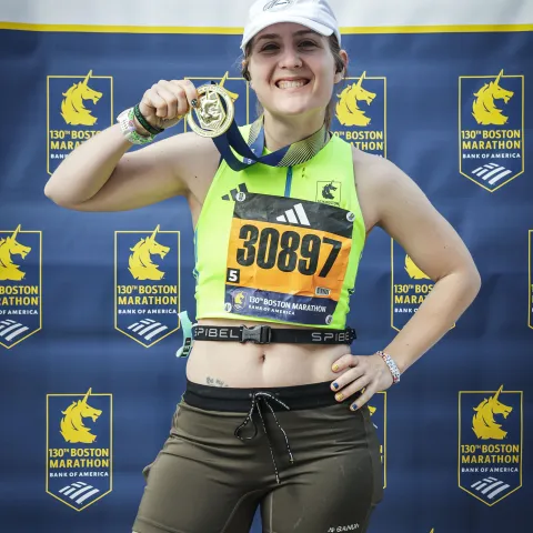 Standing with a medal