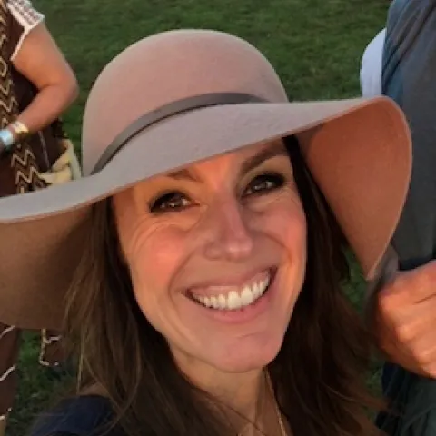 smiling woman in taupe hat