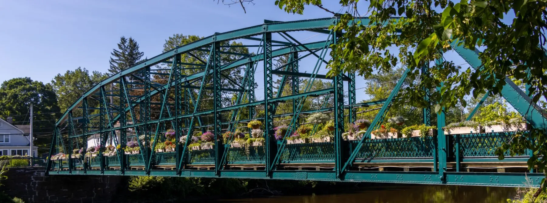 metal truss bridge lined with flowers