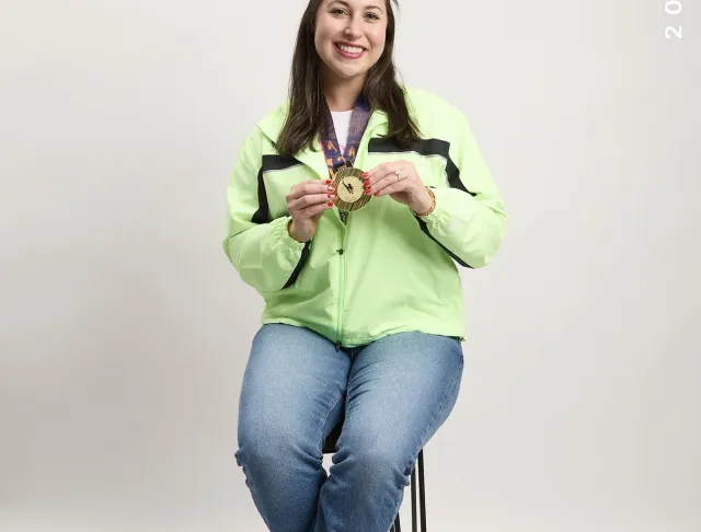 Runner posing with medal