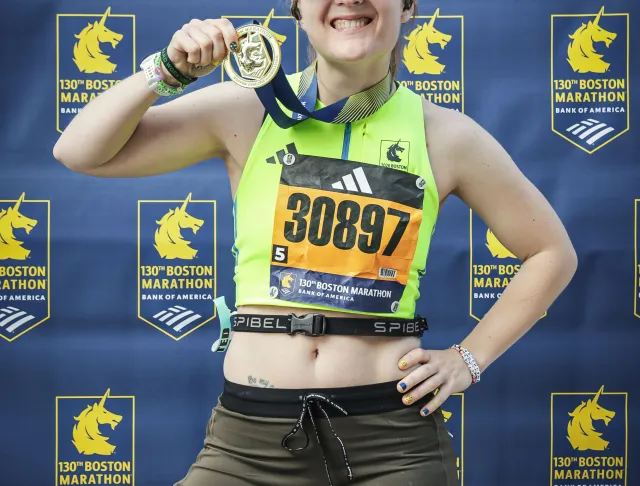 Standing with a medal