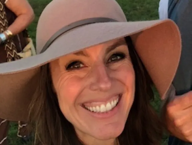 smiling woman in taupe hat